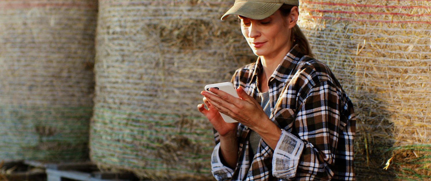 Young,Pretty,Woman,Farmer,In,Hat,Sitting,On,Hay,Stocks